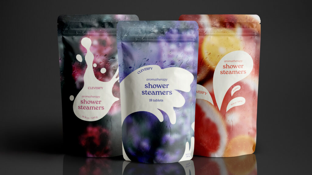 Colorful stand-up pouches of CLEVERFY aromatherapy shower steamers arranged side by side, featuring abstract splash designs in black, purple, and red tones with water droplets on the packaging.